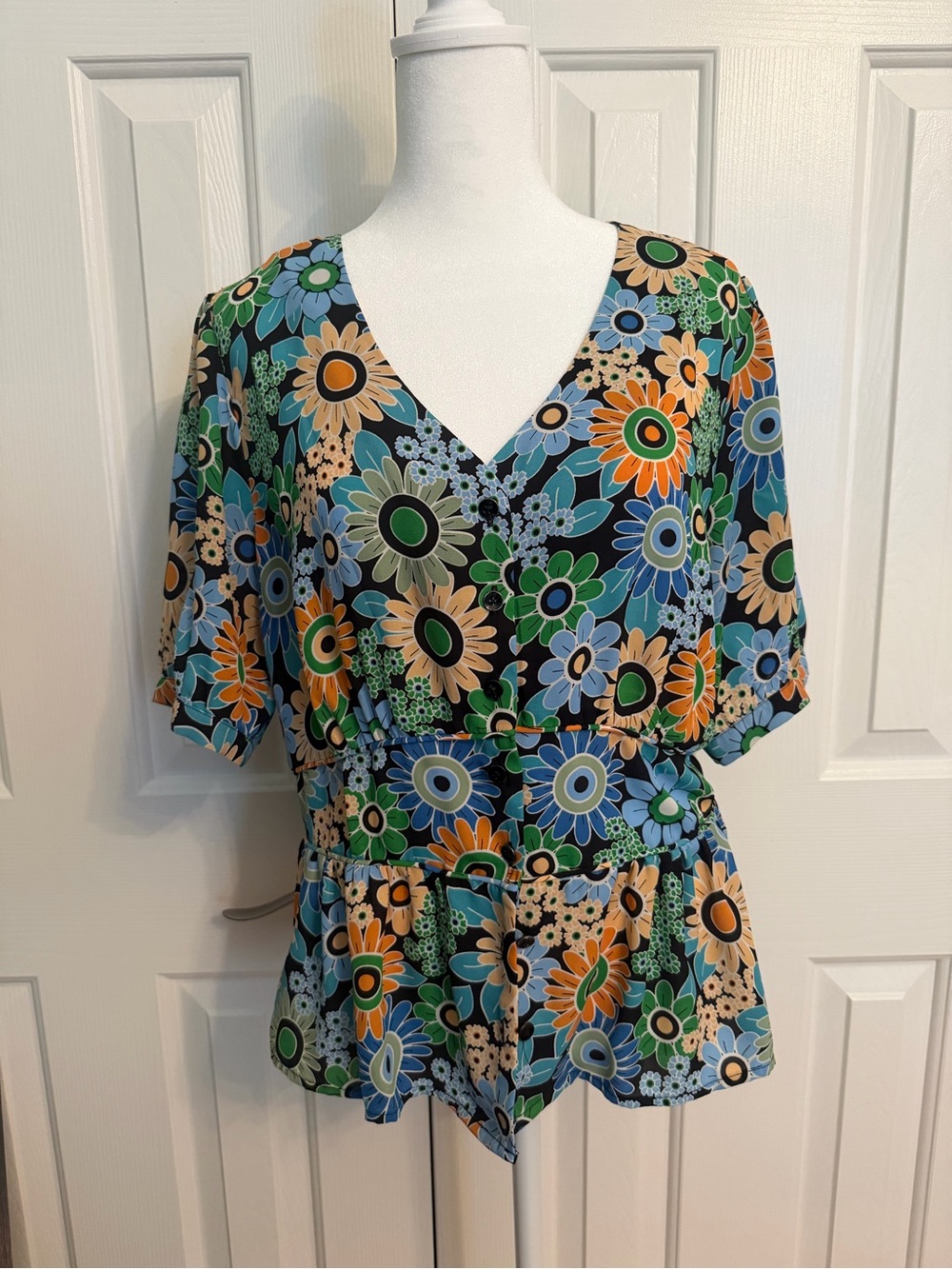 CAbi Floral V-Neck Peplum Top in Blue, Green & Orange
